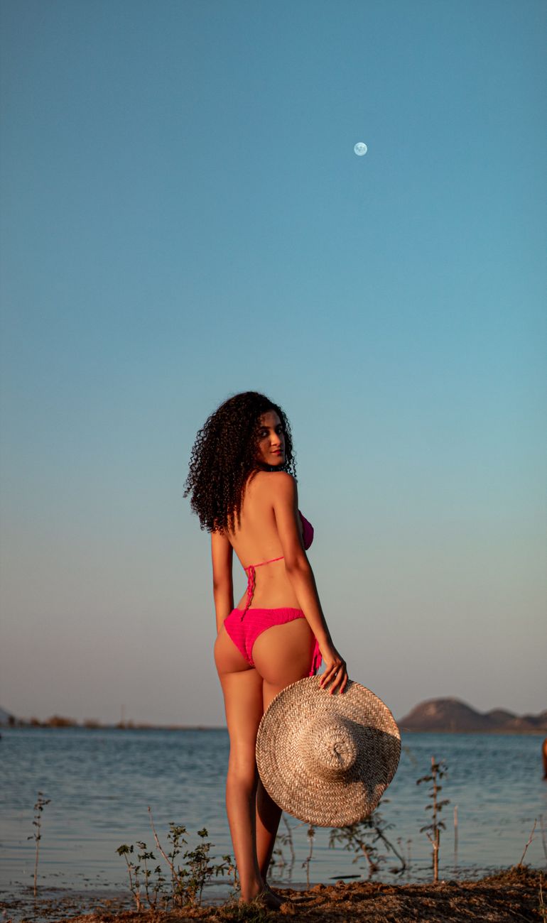 Woman in a bikini by the water